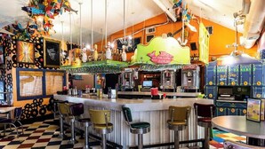 A retro-themed bar with checkered flooring, vintage bar stools, and a neon sign. - 2BR 2BA Cozy Bungalow with Backyard in Montclaire - Zilker Area (Austin)