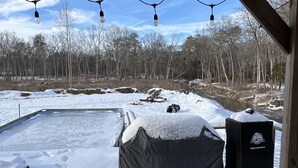 A covered outdoor area with a pool, snow-covered ground, and a tent labeled "Cuisinart Pro Series." - Charming 3-BR Cabin/House, Pool, creek, 35Acres with Fiber Internet in Pikeville (Pikeville)