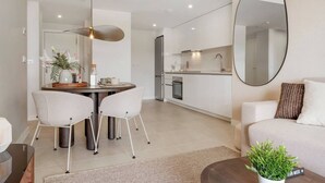 A modern kitchen with white cabinets, a built-in oven, and a stainless steel sink. - Lujo Apartments Estepona (Estepona)