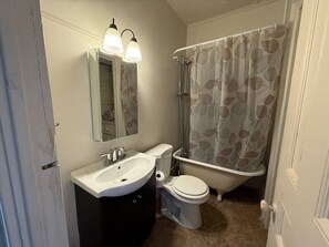 A bathroom with a white sink, toilet, and bathtub.