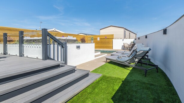 A rooftop patio with a pool, outdoor seating, and a staircase leading to an upper level. - Our WOW Lodge sets the standard for luxury accommodation. (Towyn)