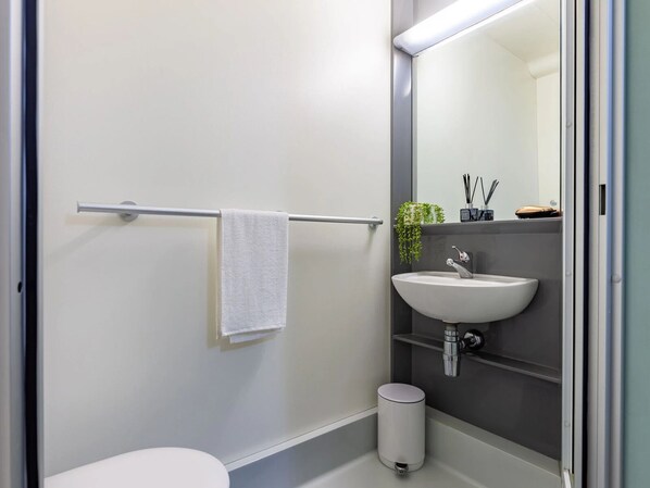 A modern bathroom with a white toilet, a sink, and a towel rack. - Student Only Kendrick Hall (Reading)