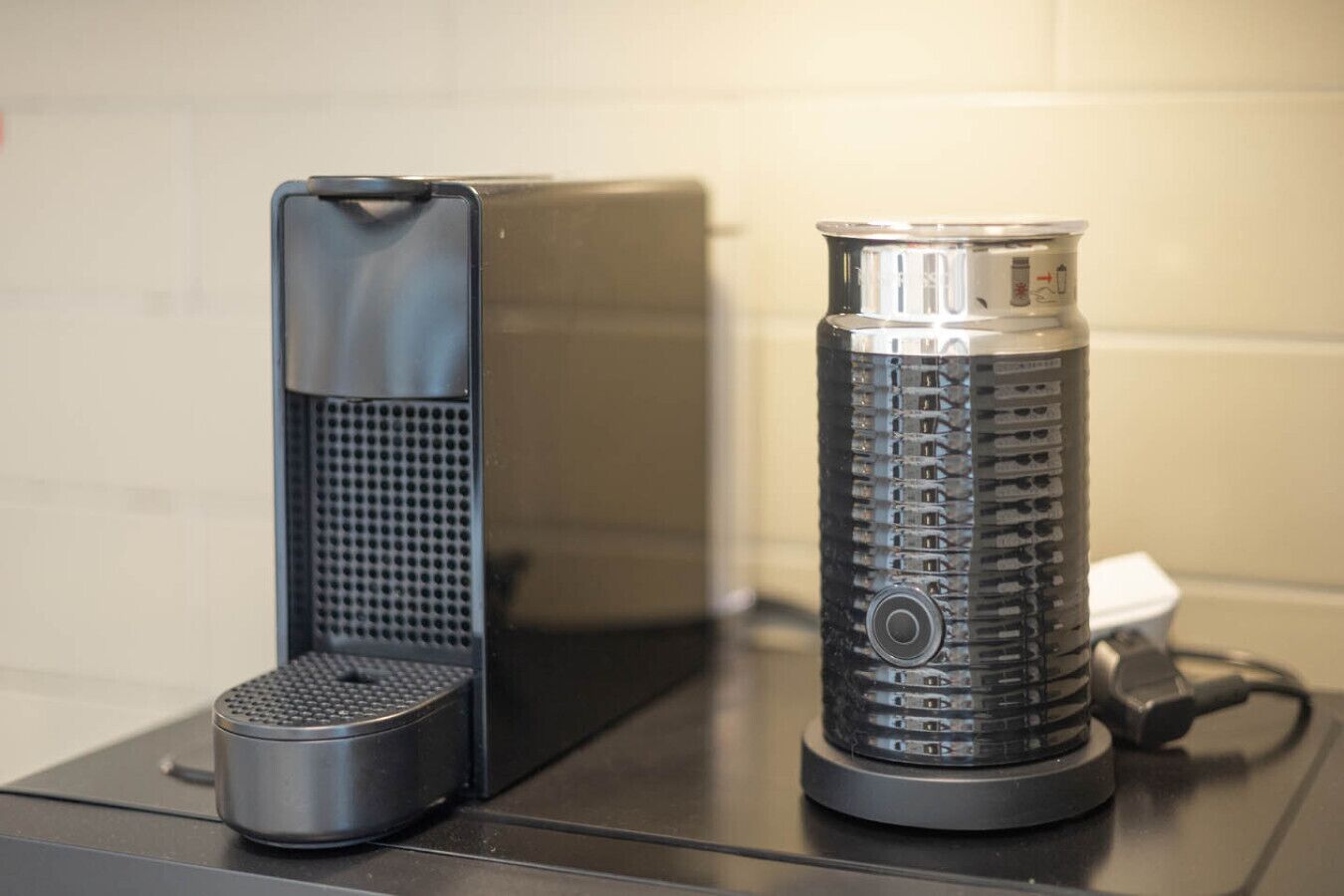 A kitchen counter with a coffee machine and a kettle.