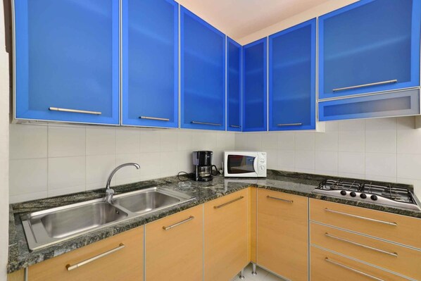 Réfrigérateur, four à micro-ondes, surface de cuisson, cafetière-théière