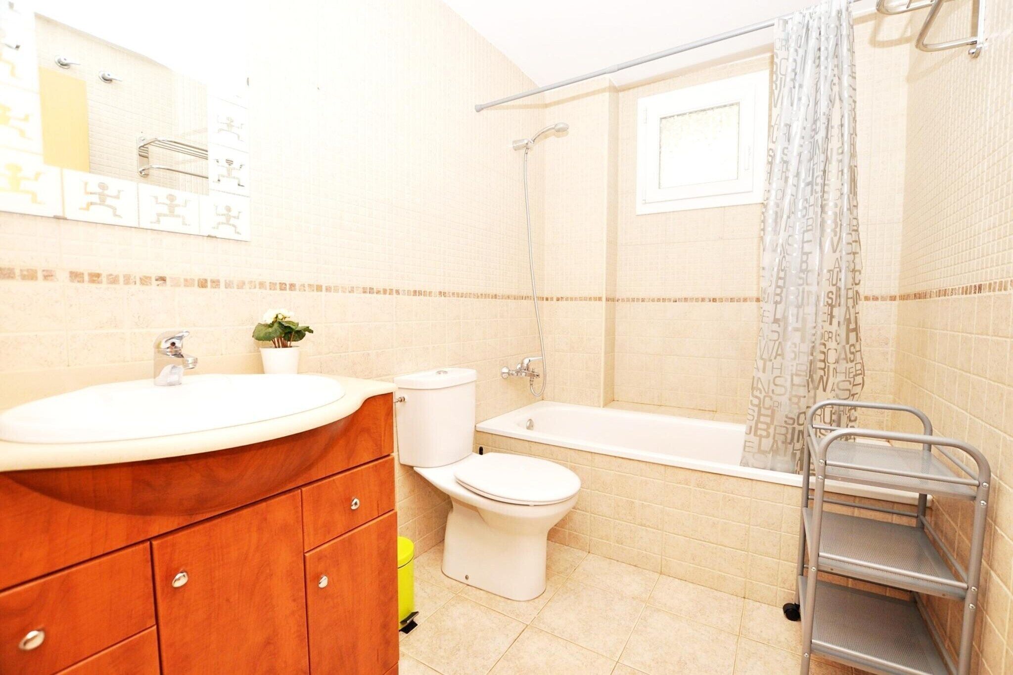 A bathroom with a sink, toilet, and bathtub.