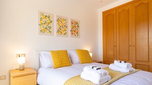A neatly arranged bedroom with a bed, bedside tables, and a wardrobe. - Stunning Views-Miraflores Apartment; Pass the Keys (Mijas)