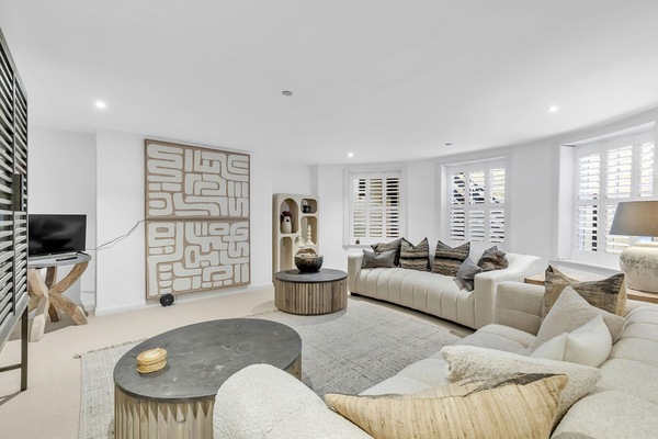 Bright lounge with sofa and Smart TV for Netflix or Prime streaming