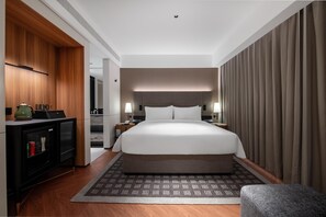 A modern hotel room with a large bed, bedside tables, a wardrobe, and a desk with a lamp. - City Inn Shanghai Xizang South Road Hotel (Shanghai)
