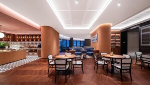 A modern hotel lobby with a central seating area, a bar, and a wine display. - City Inn Shanghai Xizang South Road Hotel (Shanghai)