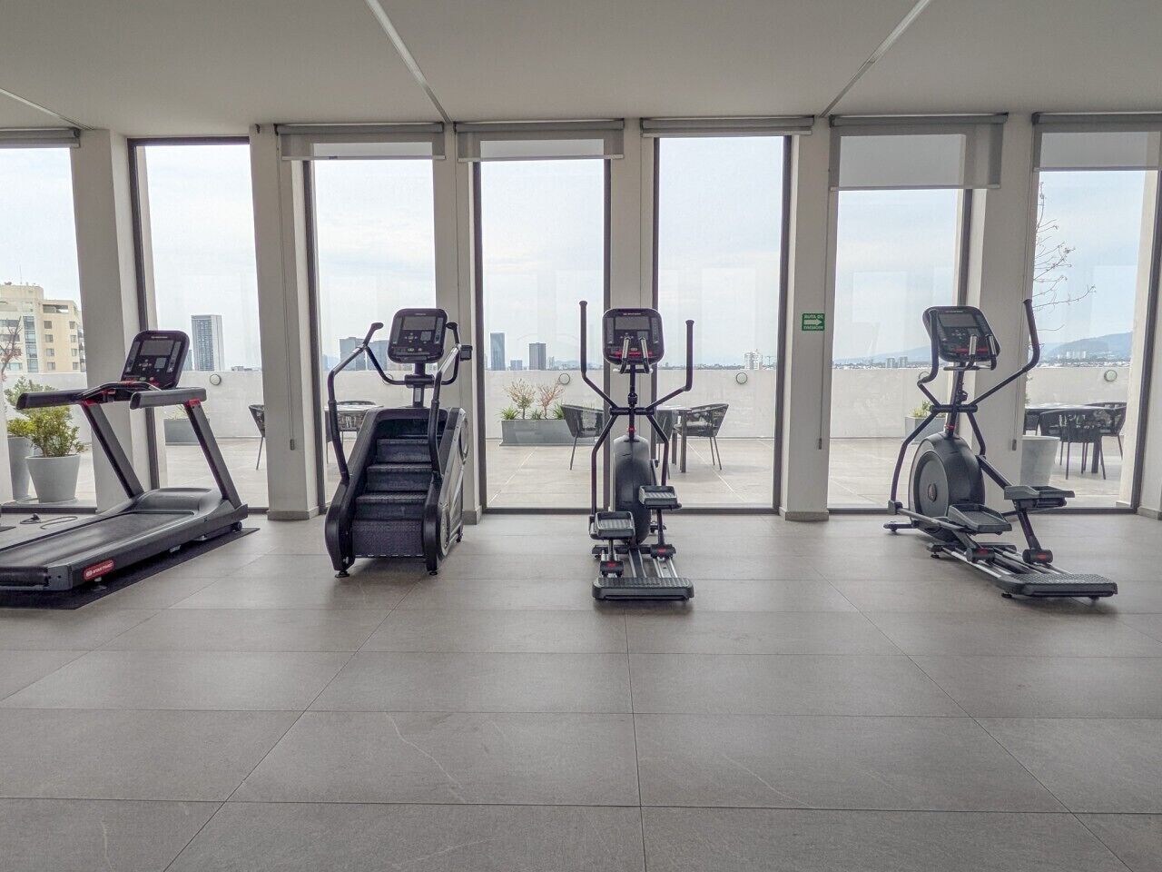 A gym with treadmills, an elliptical, and a stair climber.