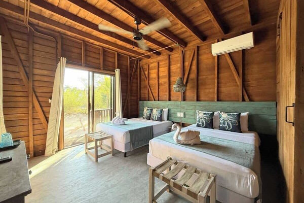 Private guest room with a comfortable queen bed and warm wooden walls