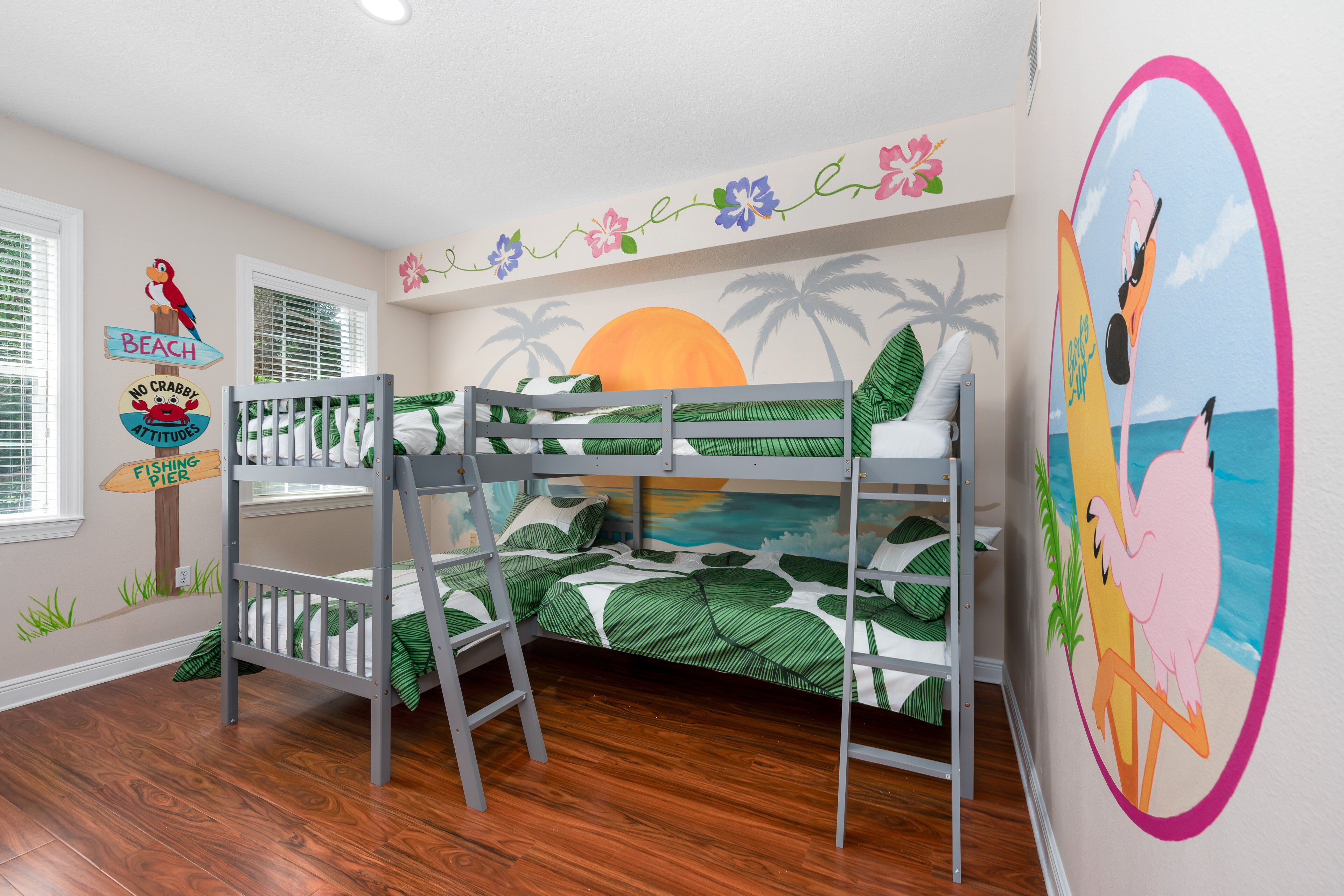 A child's bedroom with bunk beds, a beach-themed mural, and a 'No Crabby Attitudes' sign.