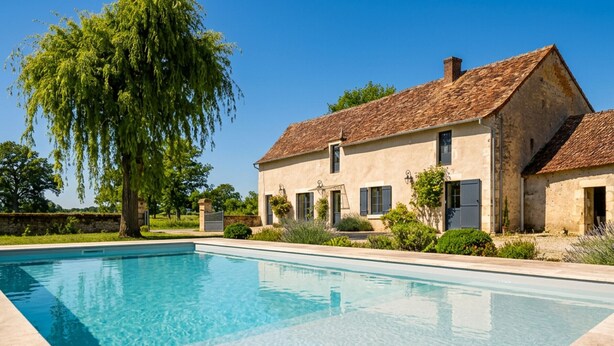 A swimming pool with a house in the background.