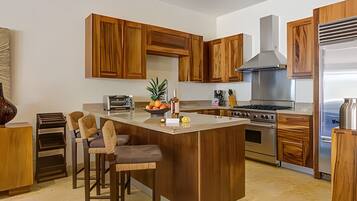 Fridge, microwave, coffee/tea maker, cookware/dishes/utensils