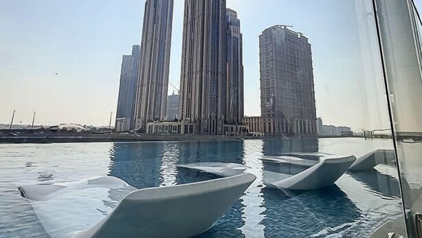 A view of tall buildings from a poolside area.
