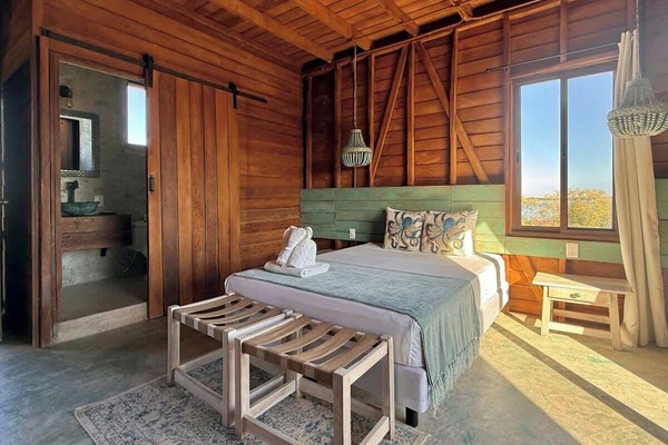 Private room with comfortable bed and wood interior