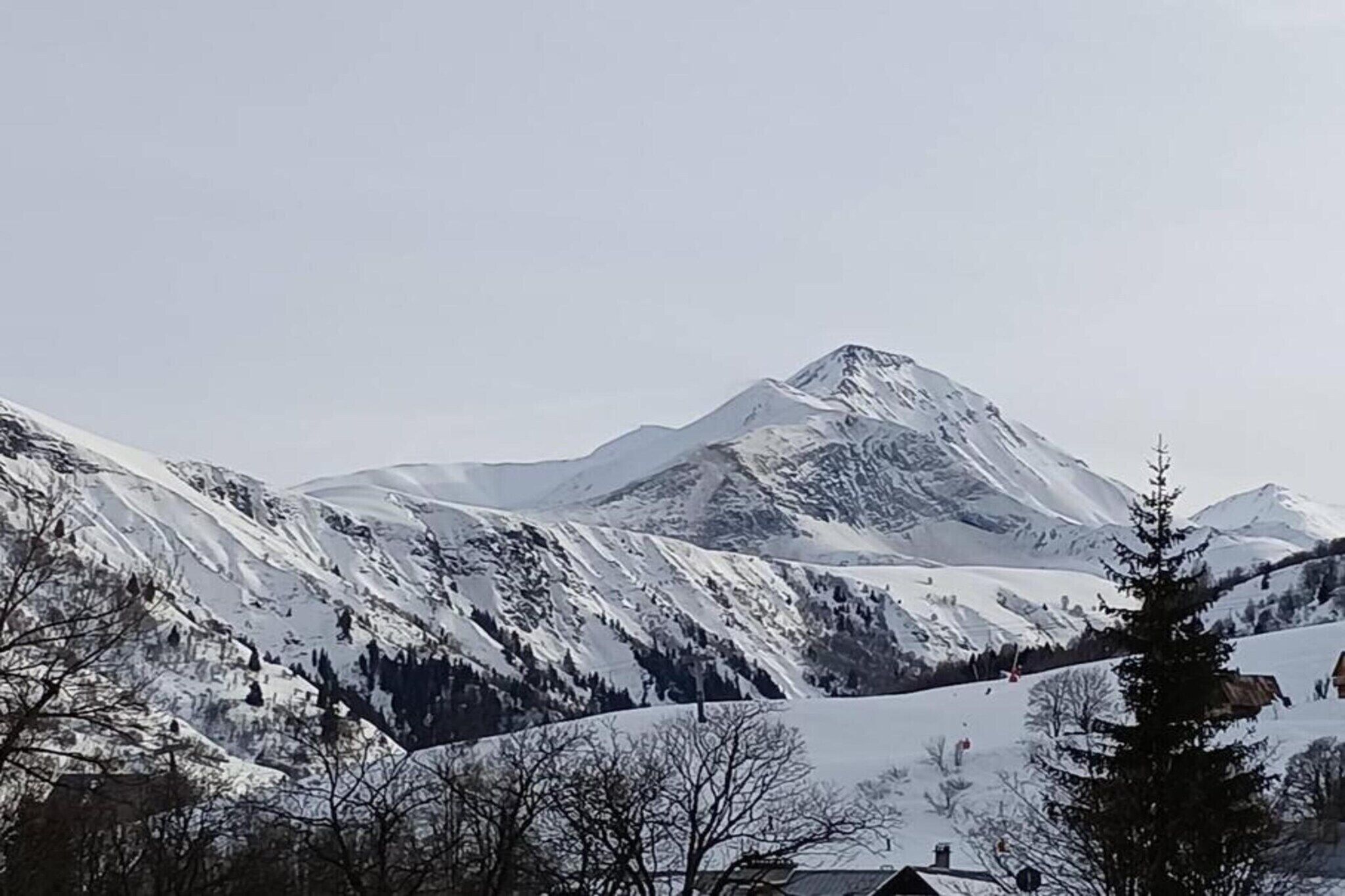 A snow-covered mountain with a clear sky.