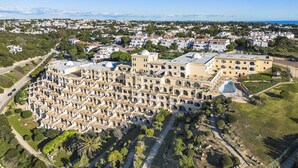 A large, multi-story hotel with numerous balconies and a central courtyard. - Casa Colina Sol 611 - Seaview apartment (Carvoeiro)