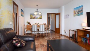 A living room with a leather sofa, a dining table with chairs, a coffee table, and a bookshelf. - Ref: 268 Stunning apartment on the beach front in Fuengirola with pool and parking (Fuengirola)