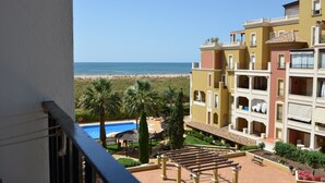 A hotel with a pool, beach view, and outdoor seating area. - Playa Grande 197 - Two Bedroom Apartment, Sleeps 5 (Punta del moral)