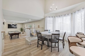 A spacious living area with a pool table, dining table with chairs, and a chandelier. - Sparkling SaltwtrPool•Spa•Firepit•Netflix•NFL+ (Phoenix)