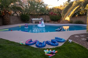 A backyard with a swimming pool, inflatable toys, and a soccer ball. - Sparkling SaltwtrPool•Spa•Firepit•Netflix•NFL+ (Phoenix)