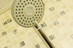 A showerhead with a circular design and multiple nozzles, mounted on a tiled wall. - Shenyang Airport Hotel (SHENYANG)