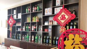 A room with a dark wooden cabinet filled with various bottles and containers. - Shenyang Airport Hotel (SHENYANG)