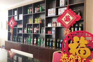 A room with a dark wooden cabinet filled with various bottles and containers. - Shenyang Airport Hotel (SHENYANG)