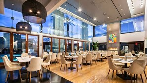 A modern restaurant with large windows, wooden floors, and contemporary lighting fixtures. - StripSuite Palms Place Hotel/Resort & Casino- NO RESORT FEE (Las Vegas)