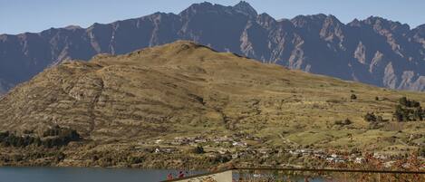 A mountainous landscape with a lake and a small settlement.