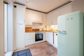 Enjoy cooking in this well-equipped kitchen with an oven and range hood.