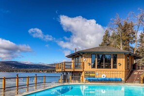 A wooden lodge with a pool and a view of a lake and mountains. - Lakefront Condo in Kings Beach- #25 (Kings Beach)