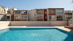 A residential building with a swimming pool, balconies, and a clear sky. - Apartment in Agde near Beach & Heated Pool (Agde)