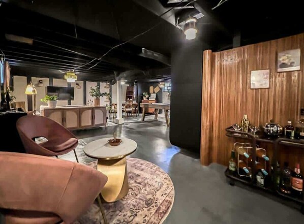 A modern interior with a bar area, seating, and a visible counter.