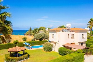 A two-story house with a swimming pool, a covered patio, and a view of the sea. - Villa Halima Georgios (Polis)