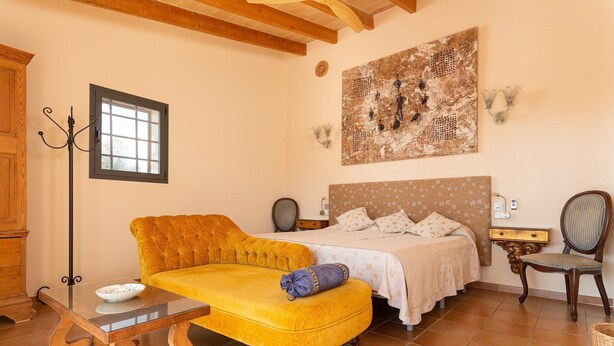 A bedroom with a bed, a sofa, a table, and a chair. - Banc Doli - Villa With Private Pool In Manacor (Manacor, Illes Balears)