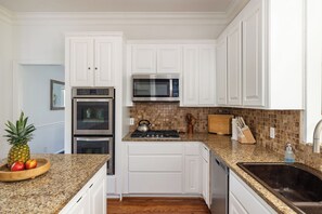 Enjoy cooking in this well-equipped kitchen with a stainless steel oven, microwave, and gas stove.
