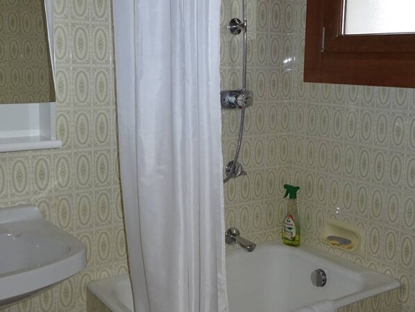A bathroom with a shower, sink, and a bottle of liquid soap. - Central Studio for 2 with Balcony, Wi-Fi, Linens & Towels Included (Les Gets)