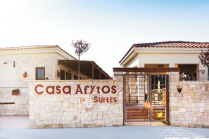 A hotel entrance with a sign reading "Casa Afytos Suites".