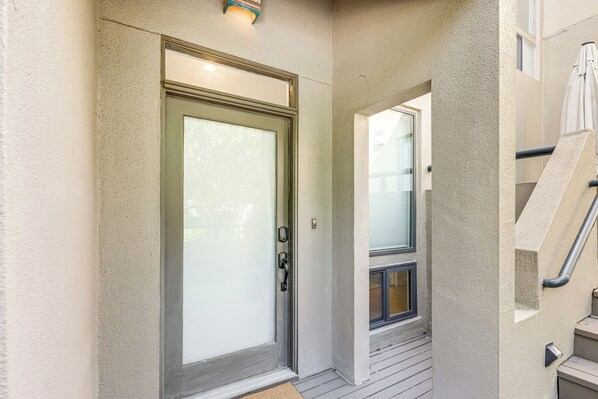 A door with a frosted glass panel, a metal handle, and a small light above it.