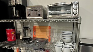 A kitchenette with a coffee maker, toaster, and oven. - Studio-close to Cleveland clinic With WiFi and AC in Cleveland Heights (Cleveland Heights)
