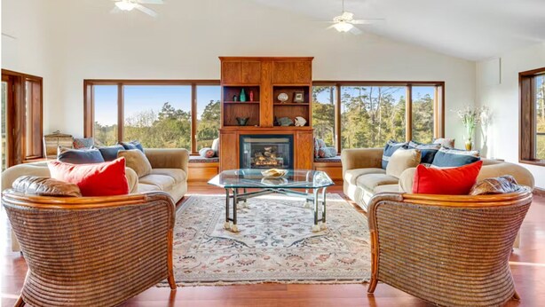 A spacious living room with wicker furniture, a glass coffee table, and a fireplace. - Family Night's Rest | Game Room | Fort Bragg (Fort Bragg)