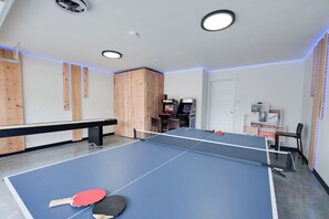 Enjoy games and leisure time with a ping pong table, books, and gaming consoles.