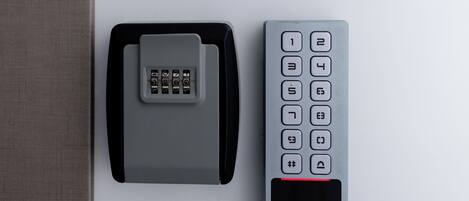 A remote control and a keycard on a white surface.