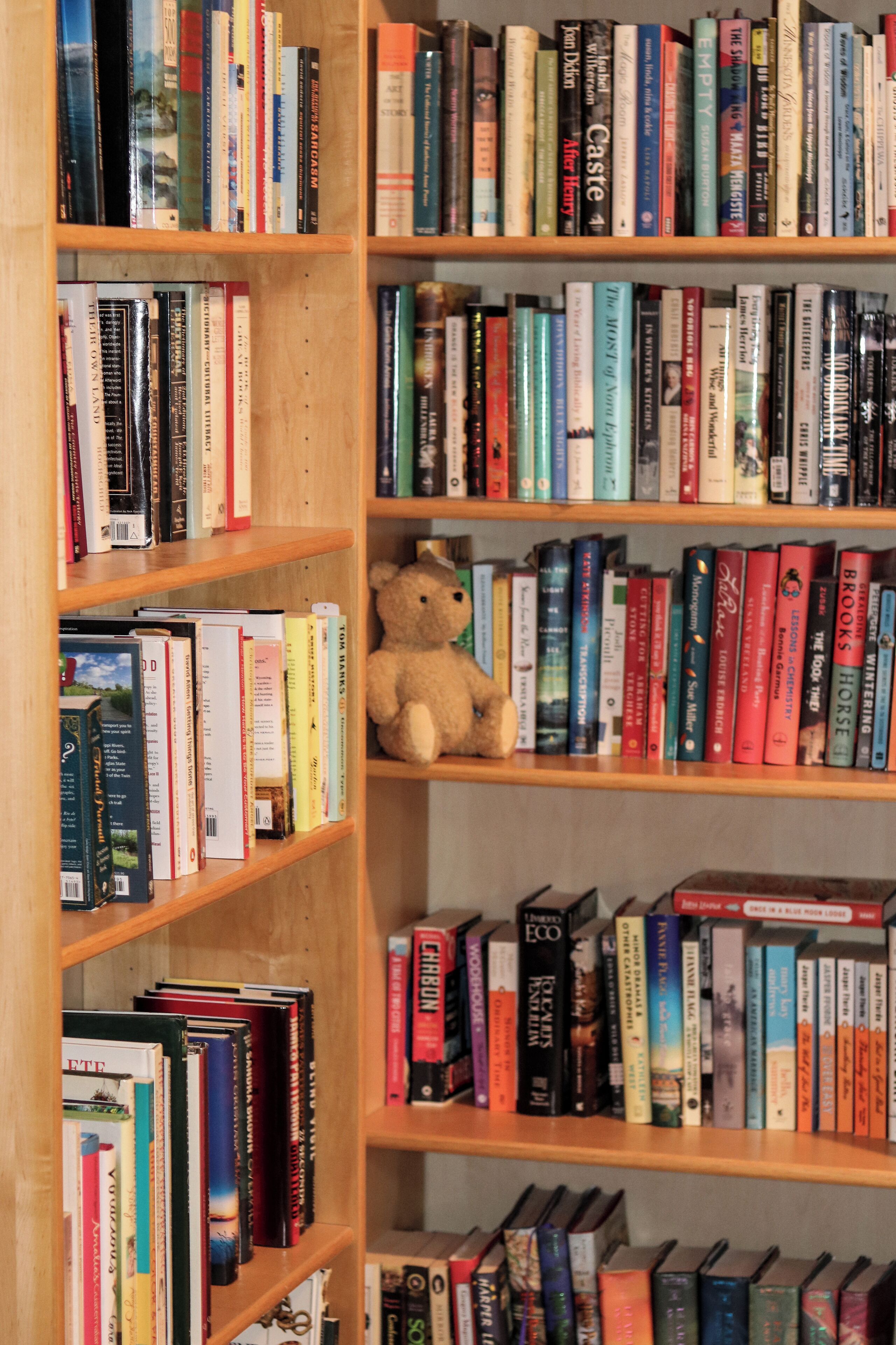 A bookshelf filled with books of various sizes and colors.
