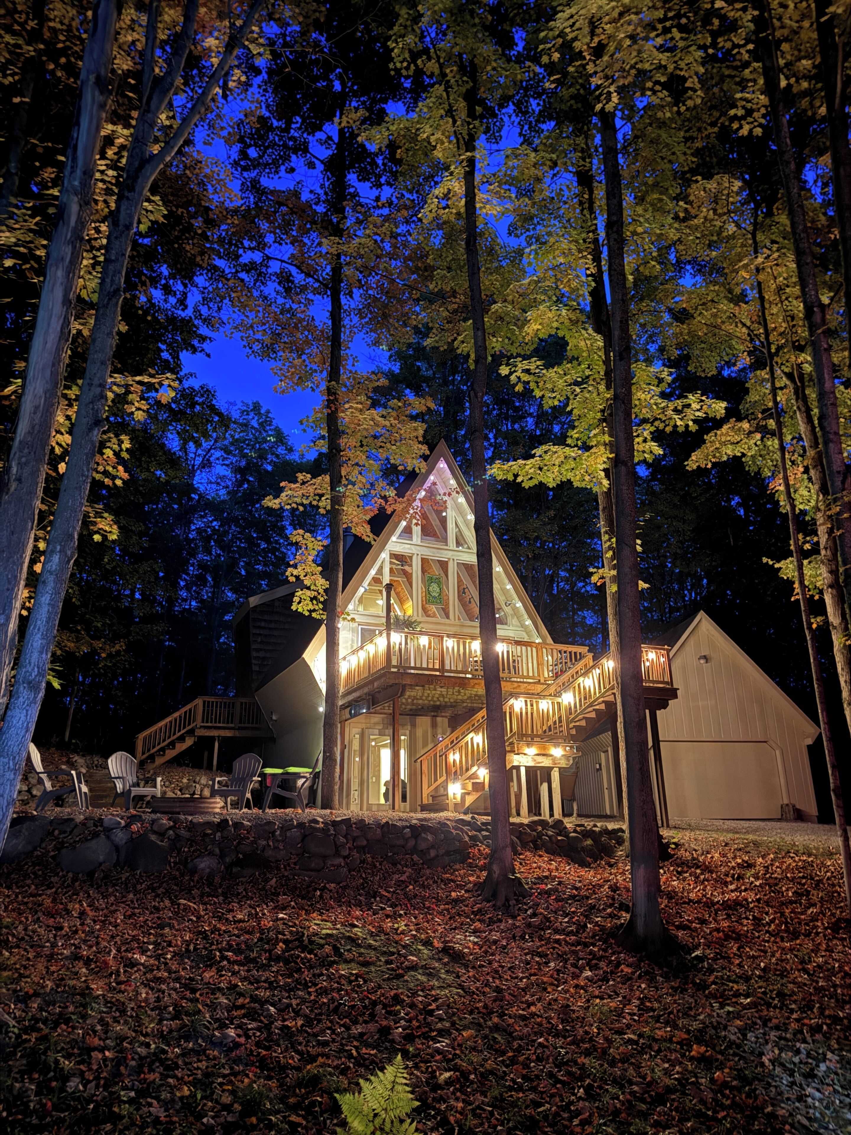 Secluded A-Frame Escape in the Woods | Close to Torch Lake + Pool Access at Lakeview Hotel. Spend your days on the water, relax by the pool, and unwind on the spacious deck surrounded by trees—your peaceful summer retreat starts here.