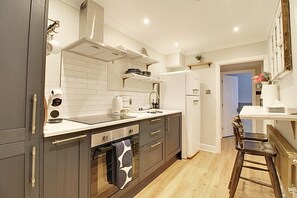 Een koelkast, een oven, een kookplaat, een koffiezetapparaat/waterkoker