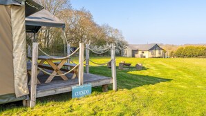 A rustic wooden deck with a sign reading "CUCKOO" leading to a tented area. - Dog Friendly Safari Tent Cuckoo at Sweffling Hall, Suffolk (Sweffling)