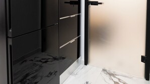 A modern room with a large wardrobe, a door with a frosted glass panel, and a marble floor. - Apartment with jacuzzi and sauna.Fully furnished with kitchen absolutely private (Katie patisia)